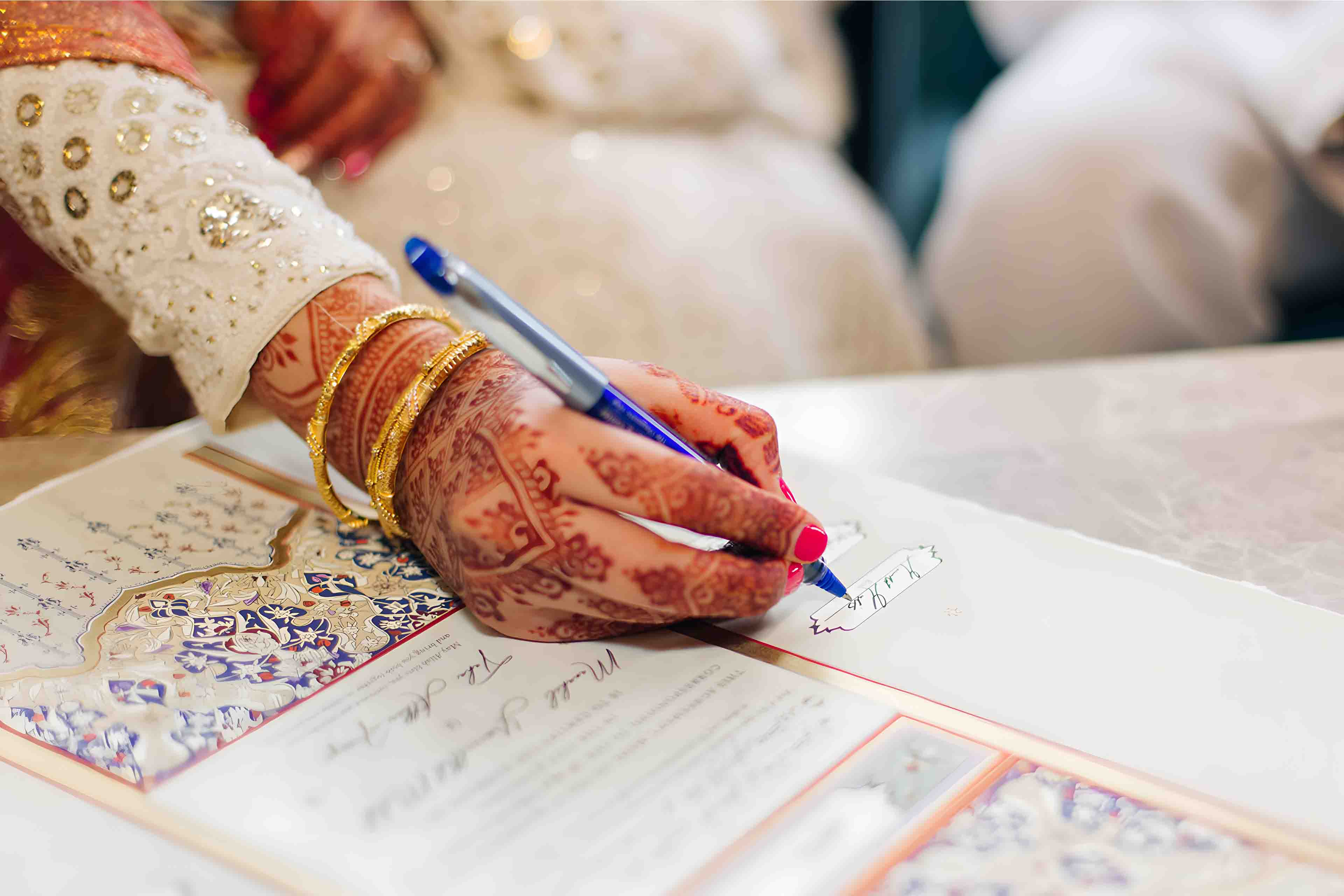 Pakistani Nikkah wedding signature moment bride holding pen